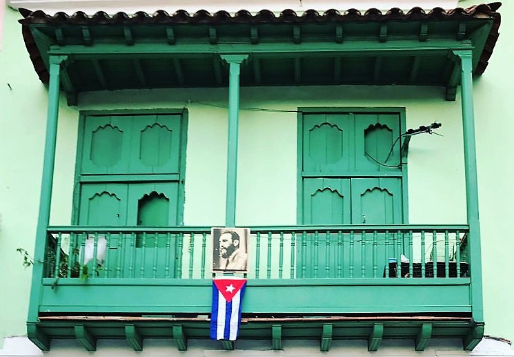 A portrait of Fidel hangs on a balcony in Havana 